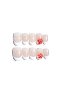 Set of false (press-on) nails with floral designs on a white background